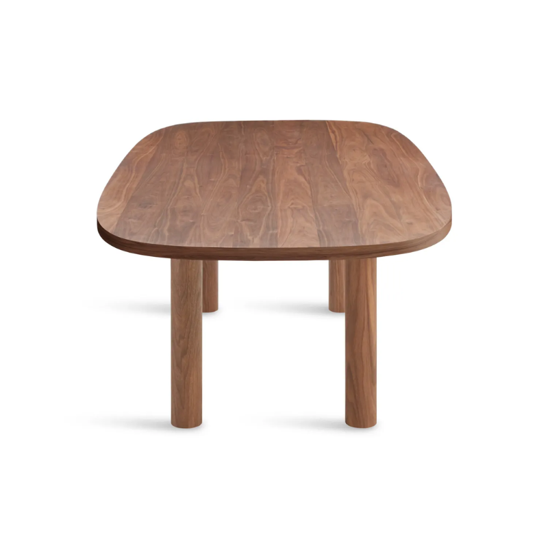 The 100 inch Good Times Dining Table from Blu Dot in walnut from the side at an angle.
