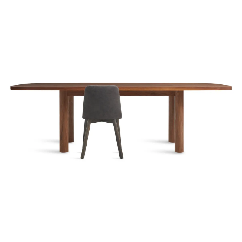 The 100 inch Good Times Dining Table from Blu Dot in walnut in a studio.