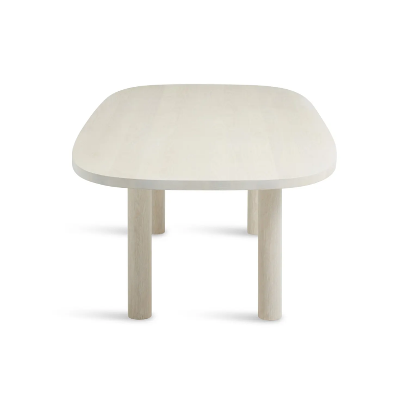 The 100 inch Good Times Dining Table from Blu Dot in whitewashed ash from the side at an angle.