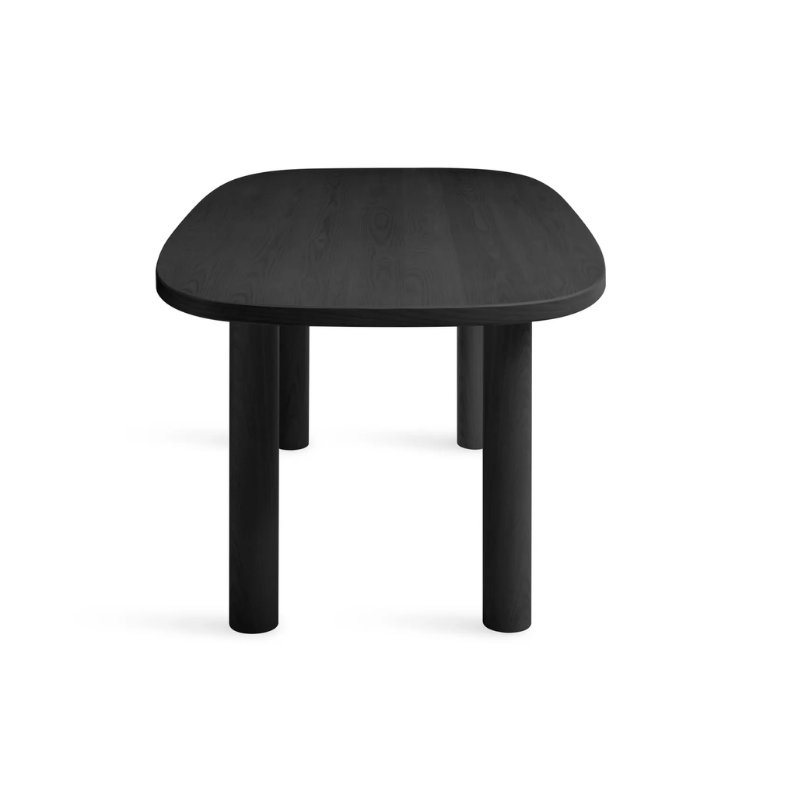 The 82 inch Good Times Dining Table from Blu Dot in black on ash from the side at an angle.