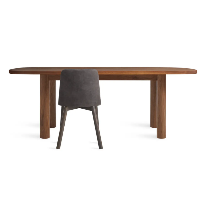 The 82 inch Good Times Dining Table from Blu Dot in walnut in a studio.