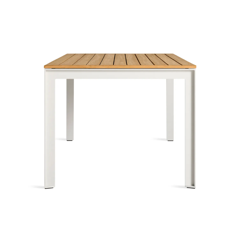 The Hold Tight 76" Outdoor Dining Table from Blu Dot in white and teak from the side.