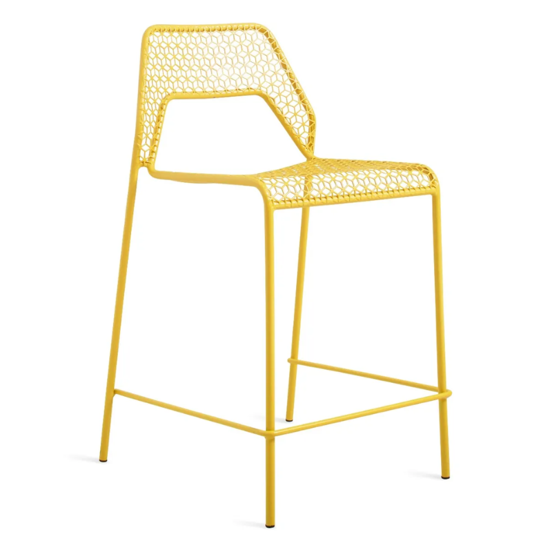 The Hot Mesh Counter Stool from Blu Dot in natural yellow from an angle.
