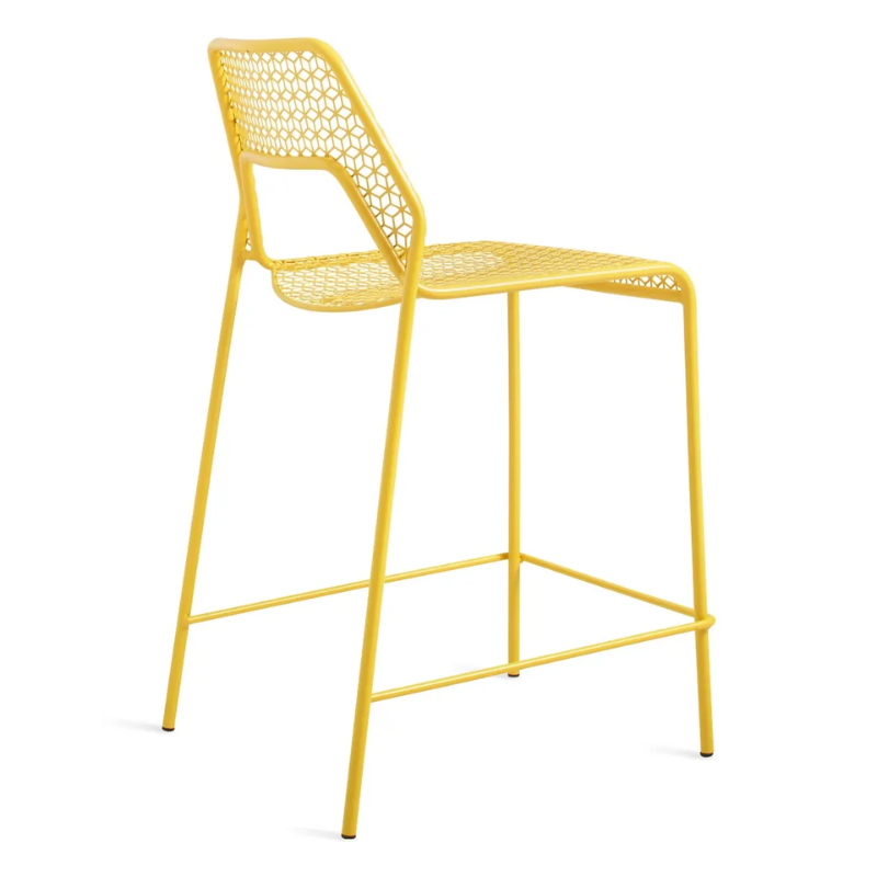 The Hot Mesh Counter Stool from Blu Dot in natural yellow from the back at an angle.