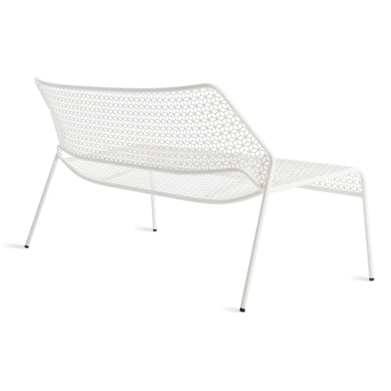 The Hot Mesh Settee from Blu Dot in white from the back at an angle.