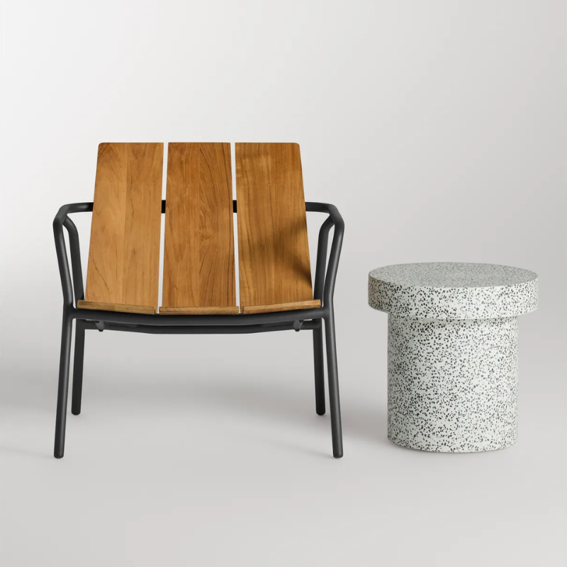 The Hunky Dory Side Table from Blu Dot in white terrazzo in a studio.