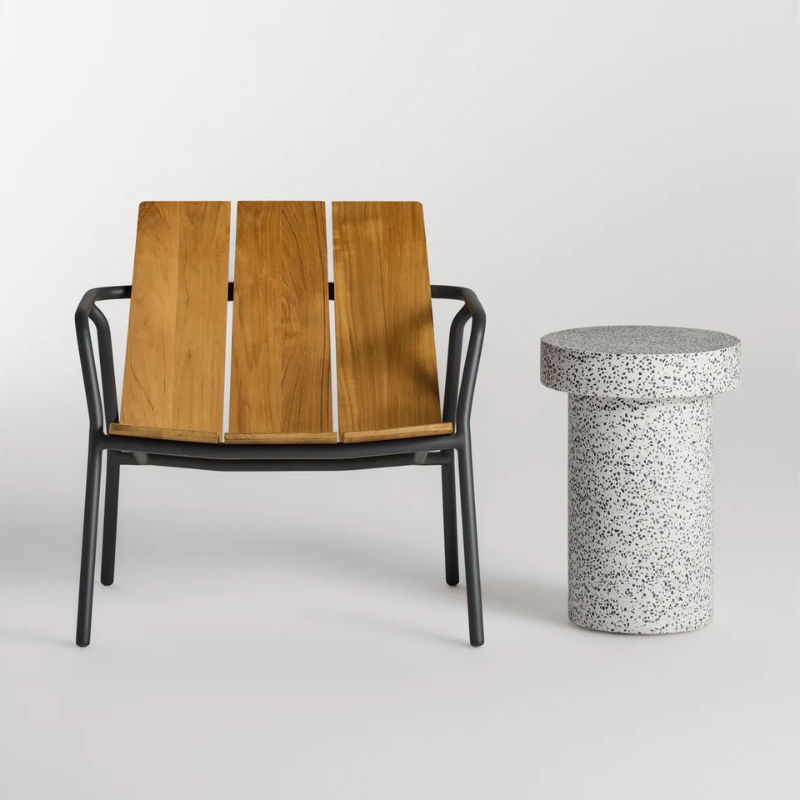 The Hunky Dory Tall Side Table from Blu Dot in white terrazzo in a studio.
