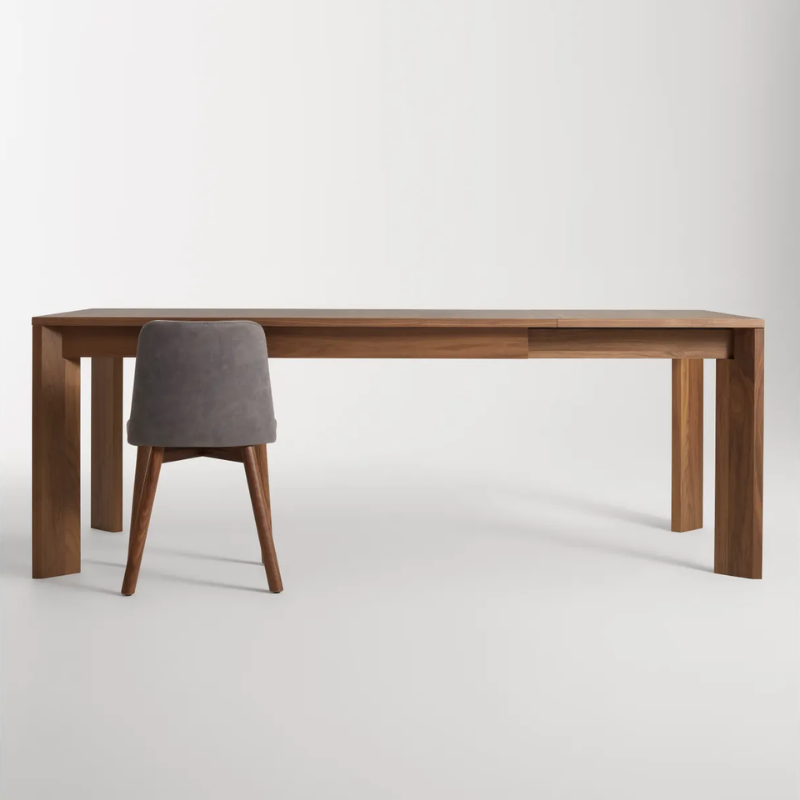 The 60 to 84 inch Moreover Extension Dining Table from Blu Dot in walnut extended in a lifestyle.