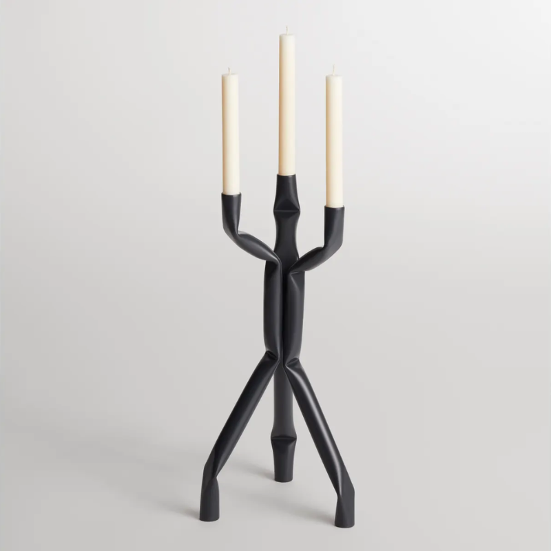 The Nosferatube Small Candelabra from Blu Dot in black in a living room studio.