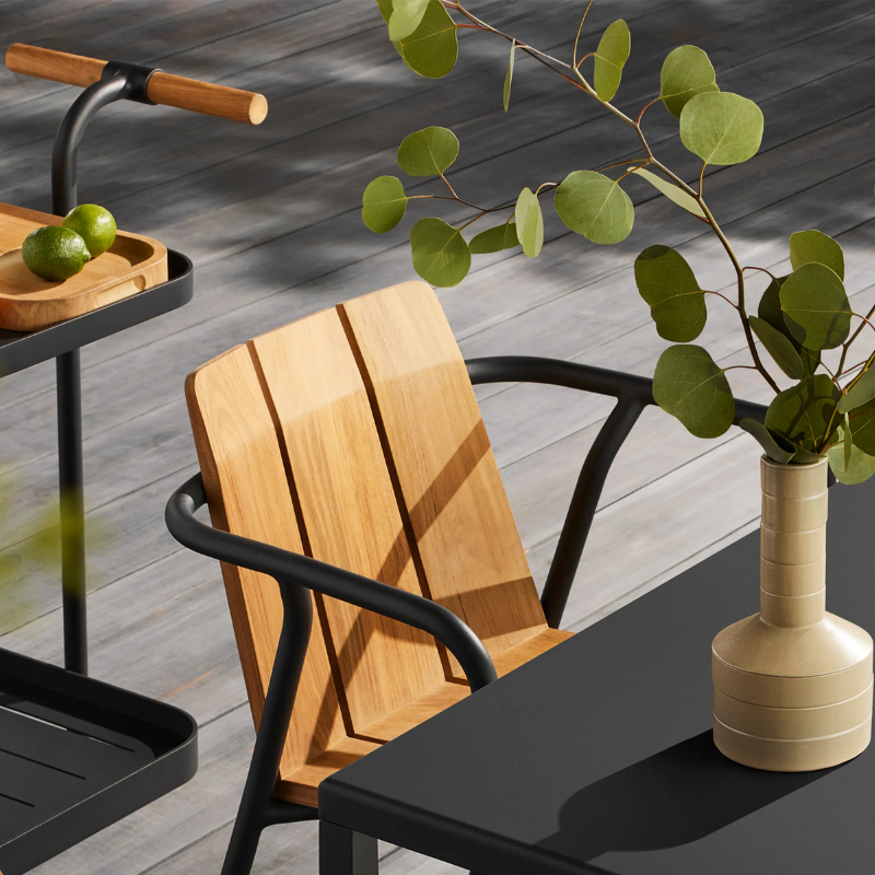 The Offline Outdoor Chair from Blu Dot in carbon in an outdoor living space.