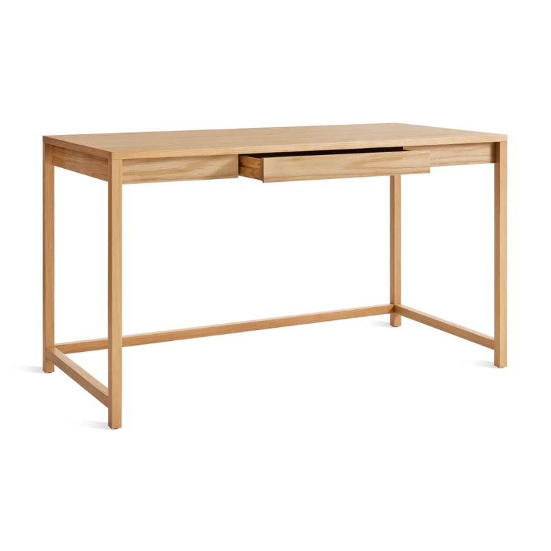 The large Open Plan Desk from Blu Dot in white oak with an open drawer.