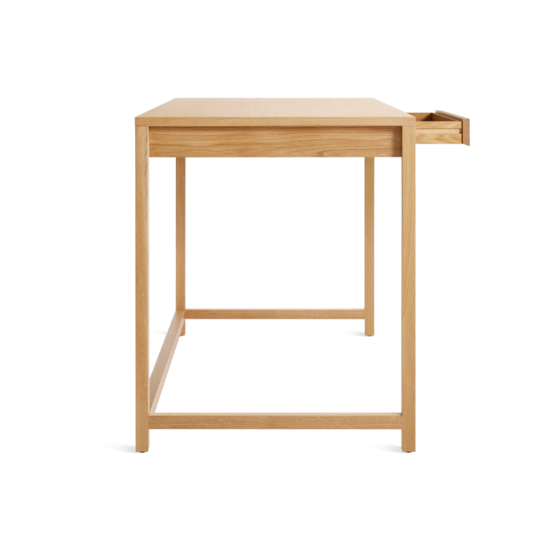The large Open Plan Desk from Blu Dot in white oak from the side with an open drawer.