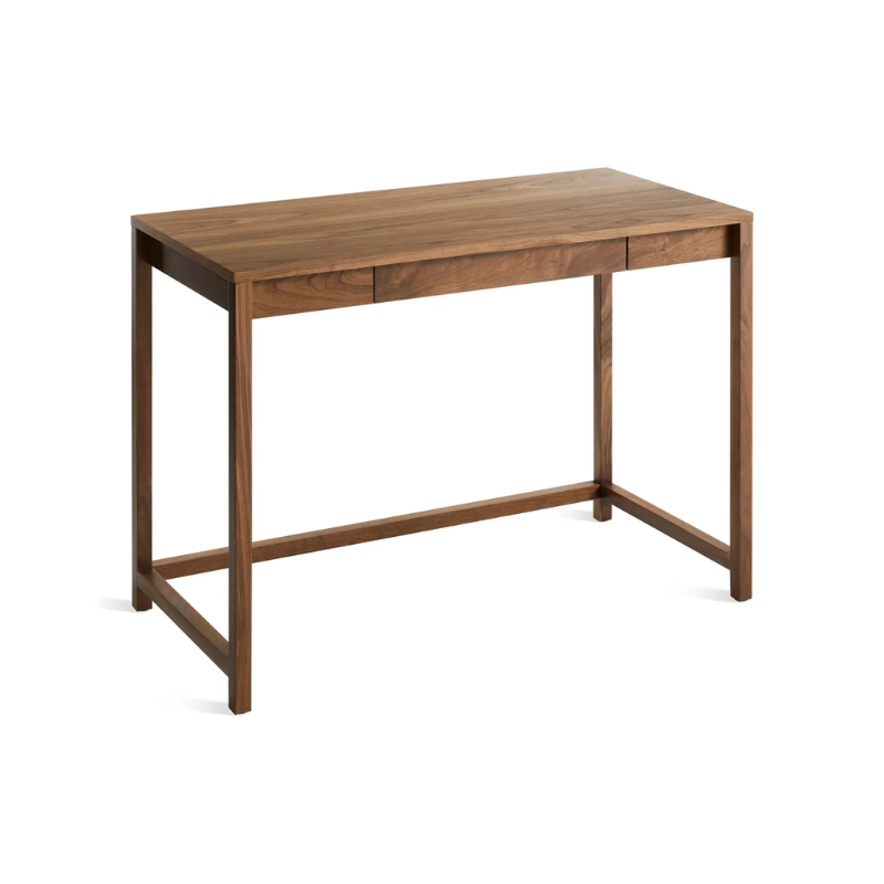 The small Open Plan Desk from Blu Dot in walnut from an angle looking at the top.