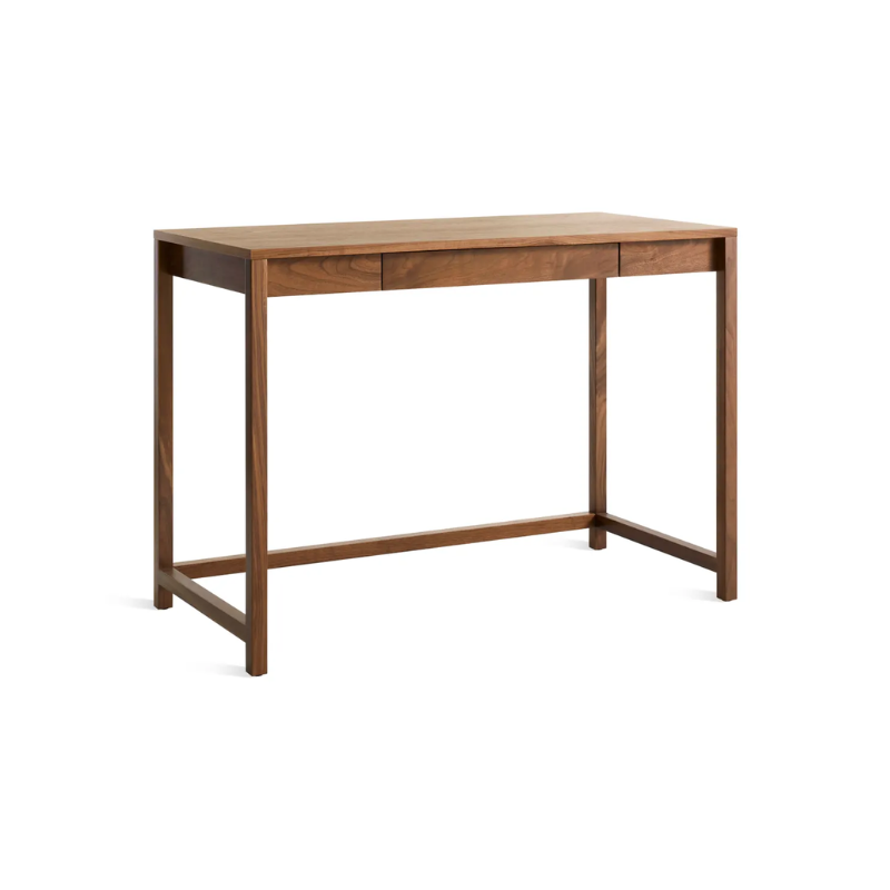 The small Open Plan Desk from Blu Dot in walnut from an angle.