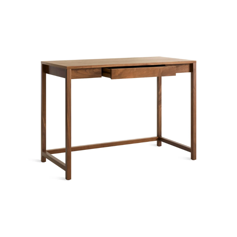 The small Open Plan Desk from Blu Dot in walnut with an open drawer.
