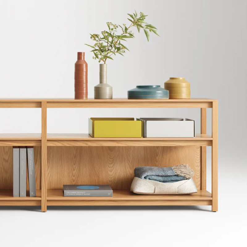 The Open Plan Long and Low Bookcase from Blu Dot in a living room.