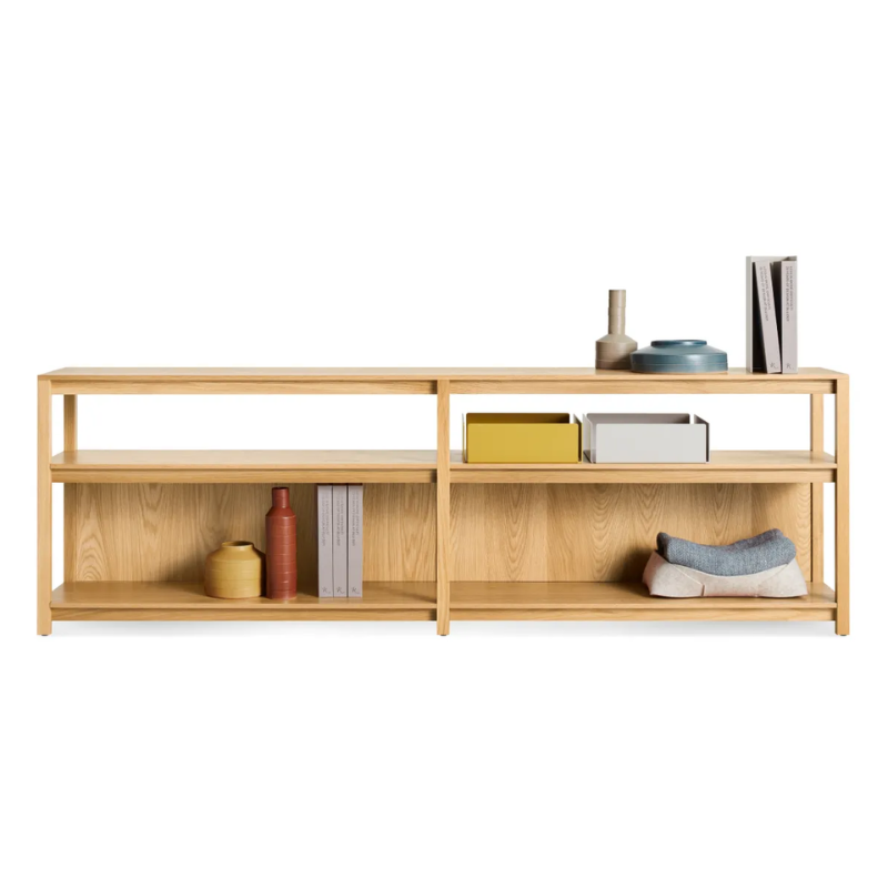 The Open Plan Long and Low Bookcase from Blu Dot in white oak in a studio.