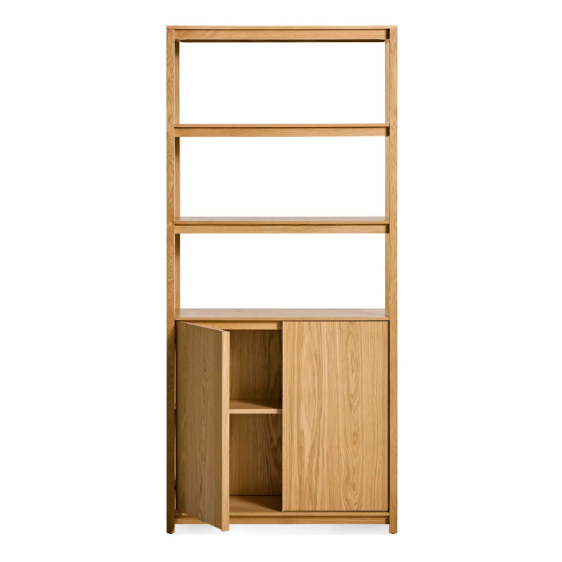 The Open Plan Tall Bookcase with Storage from Blu Dot in white oak with an open door.