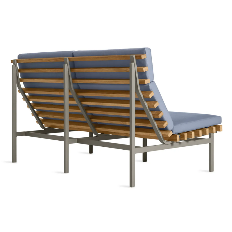 The Perch Outdoor 2 Seat Sofa from Blu Dot with charcoal frame and sunbrella haze upholstery from the back at an angle.