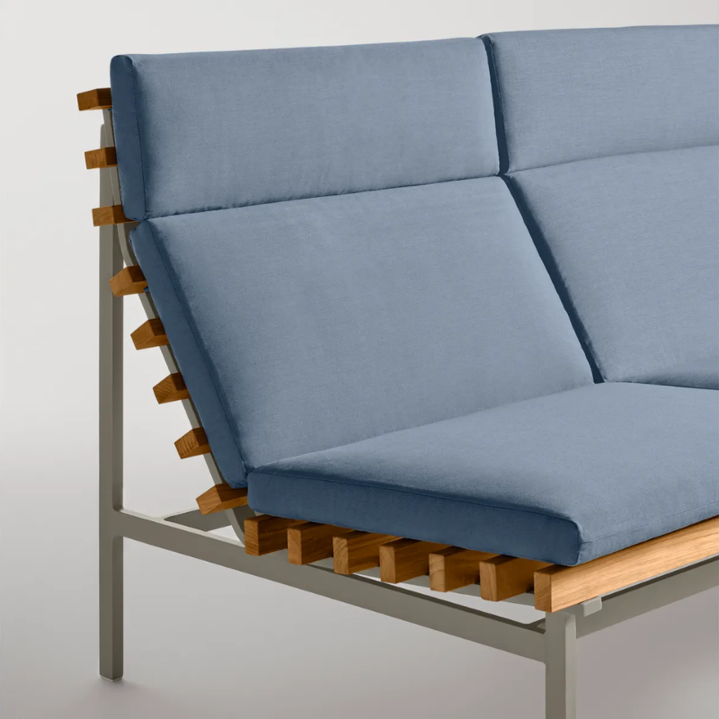 The Perch Outdoor 2 Seat Sofa from Blu Dot with charcoal frame and sunbrella haze upholstery in a studio.
