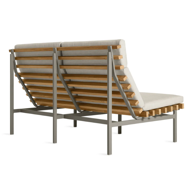 The Perch Outdoor 2 Seat Sofa from Blu Dot with charcoal frame and sunbrella linen upholstery from the back at an angle.