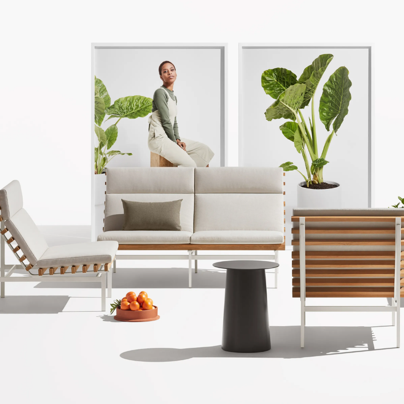 The Perch Outdoor 2 Seat Sofa from Blu Dot with charcoal frame and sunbrella linen upholstery in a living room.