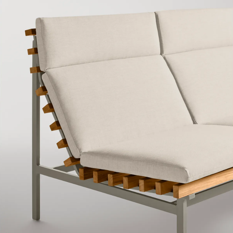 The Perch Outdoor 2 Seat Sofa from Blu Dot with charcoal frame and sunbrella linen upholstery in a studio.