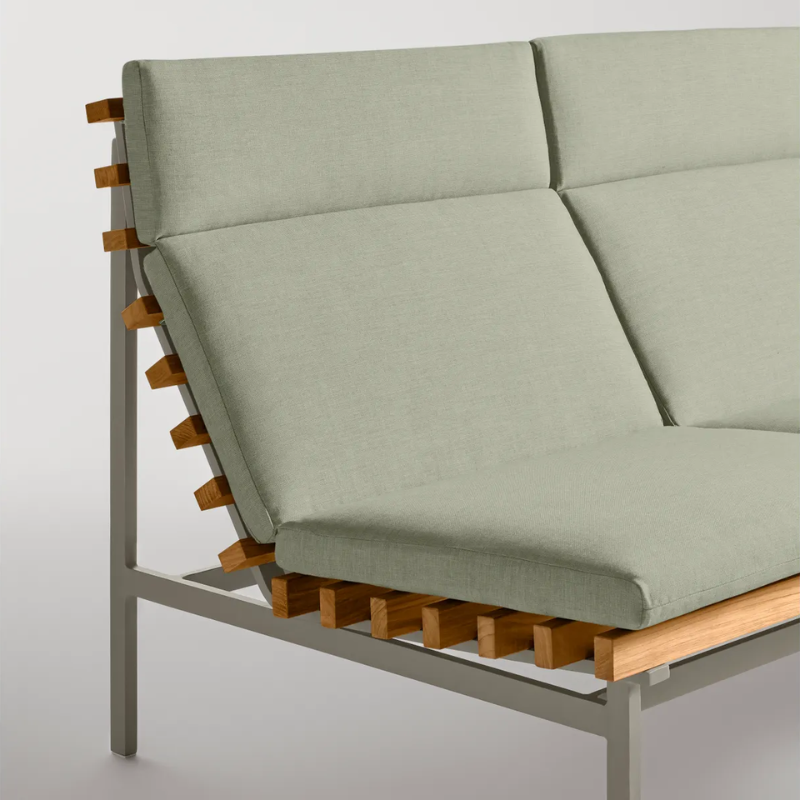 The Perch Outdoor 2 Seat Sofa from Blu Dot with carbon frame and sunbrella oasis upholstery in a studio.