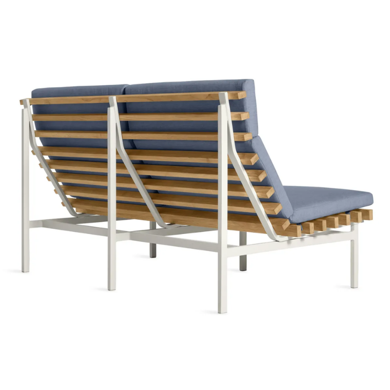 The Perch Outdoor 2 Seat Sofa from Blu Dot with white frame and sunbrella haze upholstery from the back at an angle.