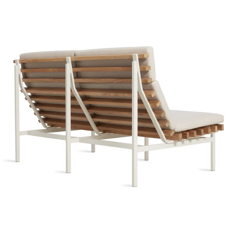 The Perch Outdoor 2 Seat Sofa from Blu Dot with white frame and sunbrella linen upholstery from the back at an angle.