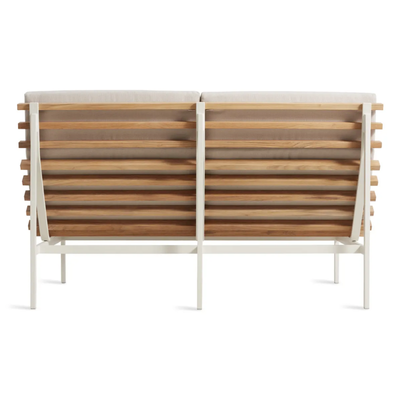 The Perch Outdoor 2 Seat Sofa from Blu Dot with white frame and sunbrella linen upholstery from the back.