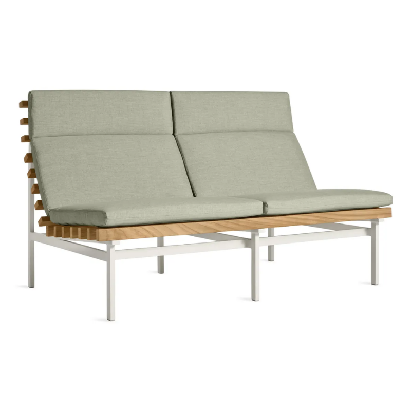 The Perch Outdoor 2 Seat Sofa from Blu Dot with white frame and sunbrella oasis upholstery from an angle.