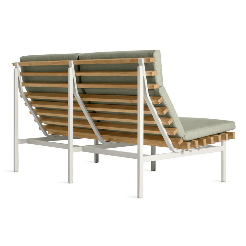 The Perch Outdoor 2 Seat Sofa from Blu Dot with white frame and sunbrella oasis upholstery from the back at an angle.