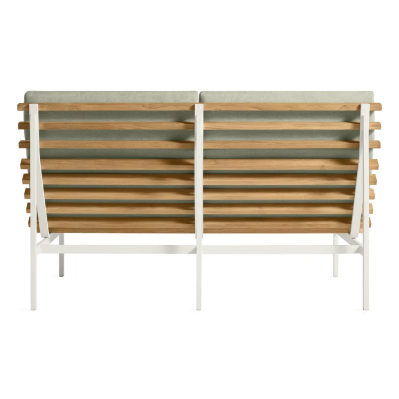 The Perch Outdoor 2 Seat Sofa from Blu Dot with white frame and sunbrella oasis upholstery from the back.