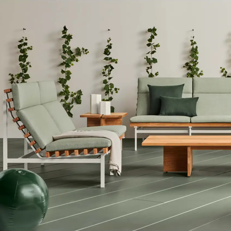 The Perch Outdoor 2 Seat Sofa from Blu Dot with white frame and sunbrella oasis upholstery in a family room.