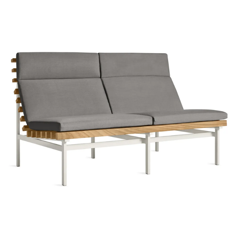 The Perch Outdoor 2 Seat Sofa from Blu Dot with white frame and toohey charcoal upholstery from an angle.