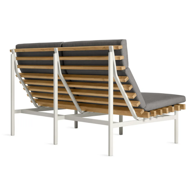 The Perch Outdoor 2 Seat Sofa from Blu Dot with white frame and toohey charcoal upholstery from the back at an angle.