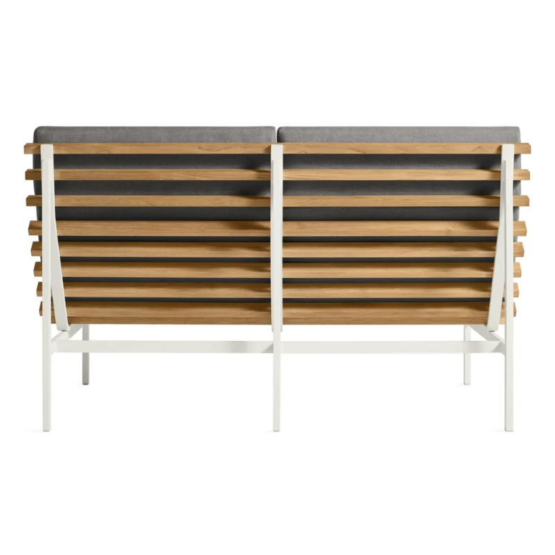 The Perch Outdoor 2 Seat Sofa from Blu Dot with white frame and toohey charcoal upholstery from the back.