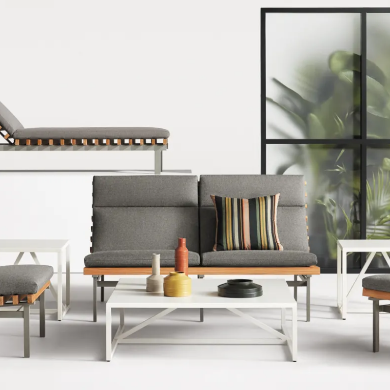 The Perch Outdoor 2 Seat Sofa from Blu Dot with charcoal frame and toohey charcoal upholstery in a living space.