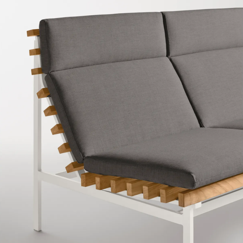 The Perch Outdoor 2 Seat Sofa from Blu Dot with white frame and toohey charcoal upholstery in a studio.