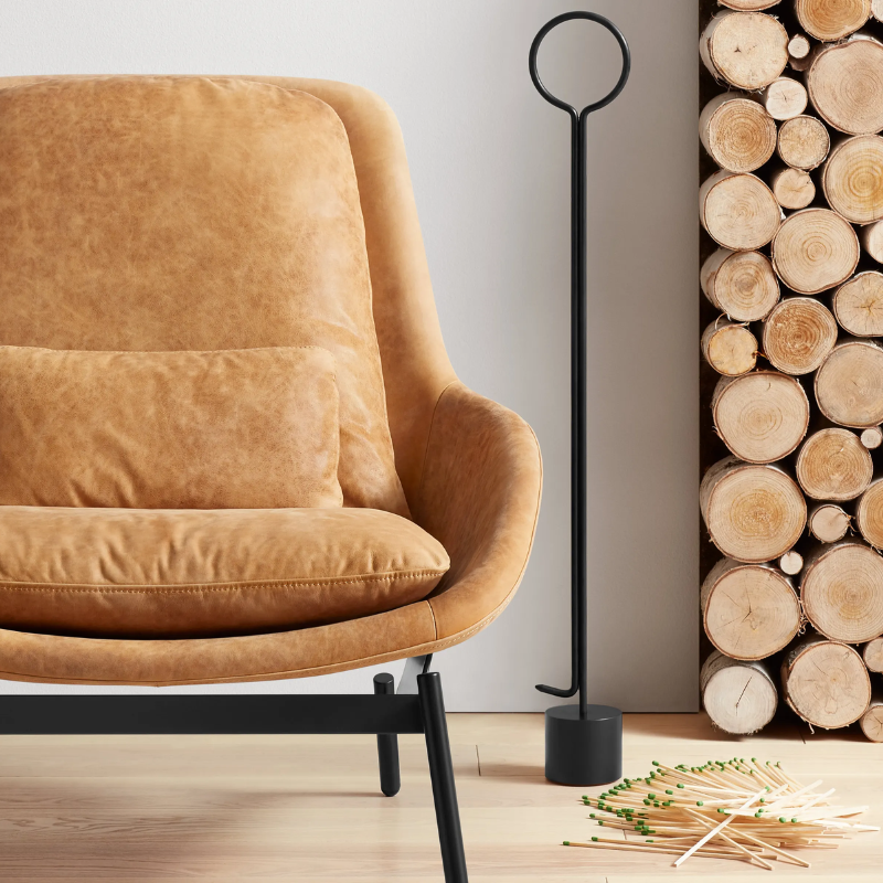 The Pokey von Pokerson Fire Poker from Blu Dot in a living room.