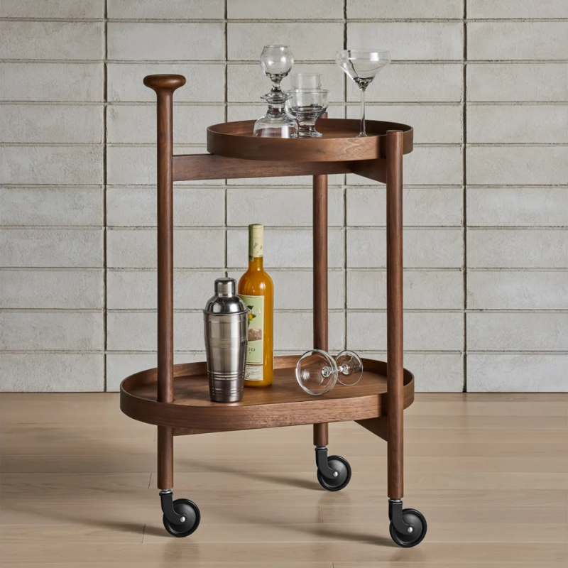 The Pose Bar Cart from Blu Dot in walnut in a living room.