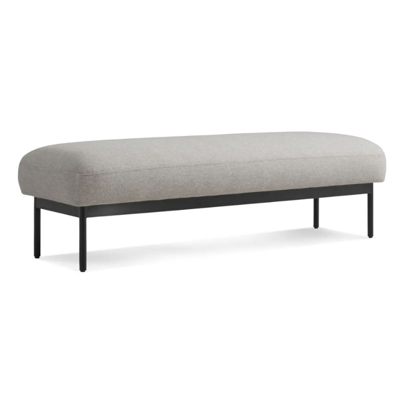 The Puff Puff Bench from Blu Dot with edwards light grey fabric upholstery from an angle.