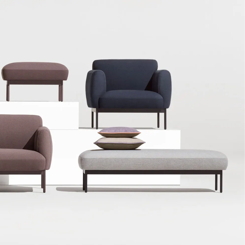 The Puff Puff Bench from Blu Dot with edwards light grey fabric upholstery in a living room studio.