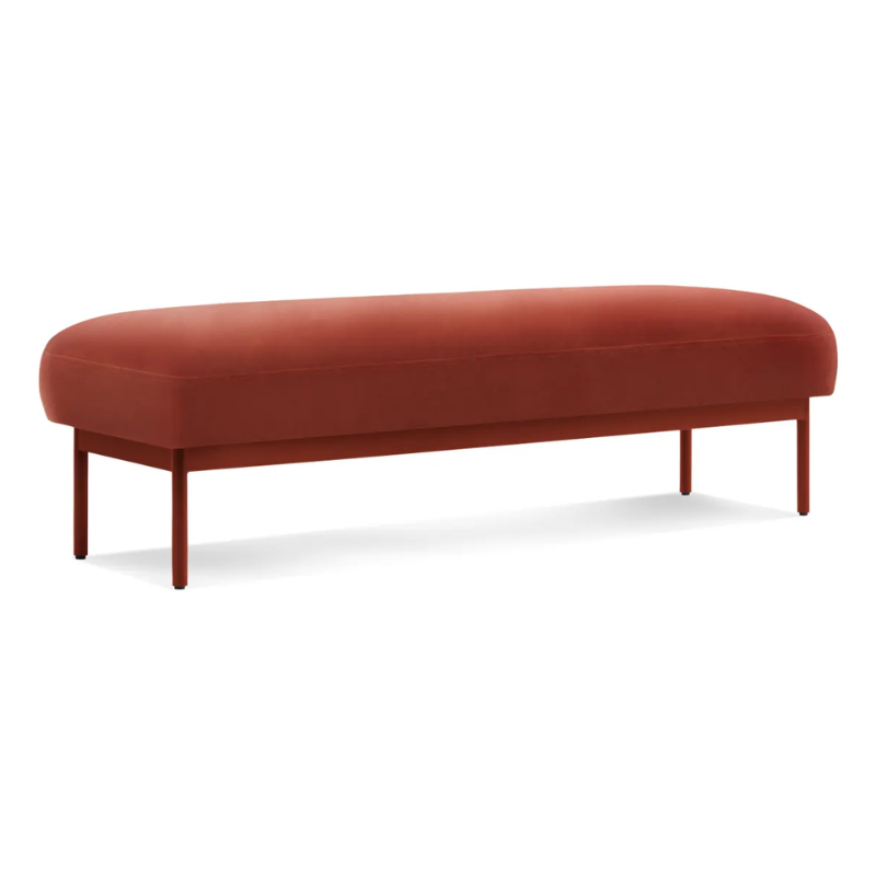 The Puff Puff Bench from Blu Dot with tomato velvet upholstery from an angle.