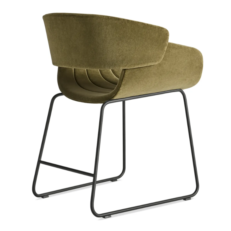 The Racer Chair from Blu Dot with Moss Velvet upholstery from the back at an angle.