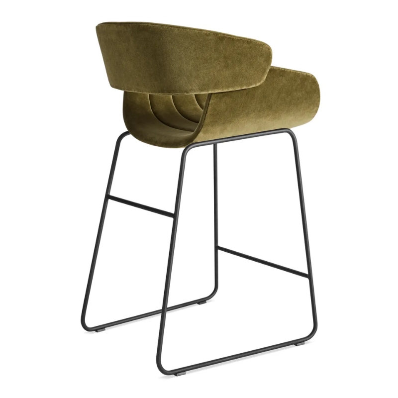 The Racer Counter Stool from Blu Dot in Moss Velvet upholstery from the back at an angle.