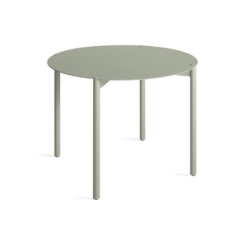 The Round Comeuppance Dining Table from Blu Dot in grey green from an angle.
