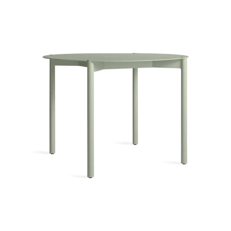 The Round Comeuppance Dining Table from Blu Dot in grey green from the side.