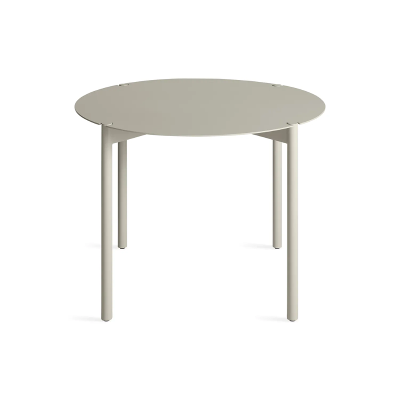 The Round Comeuppance Dining Table from Blu Dot in putty from a high angle.